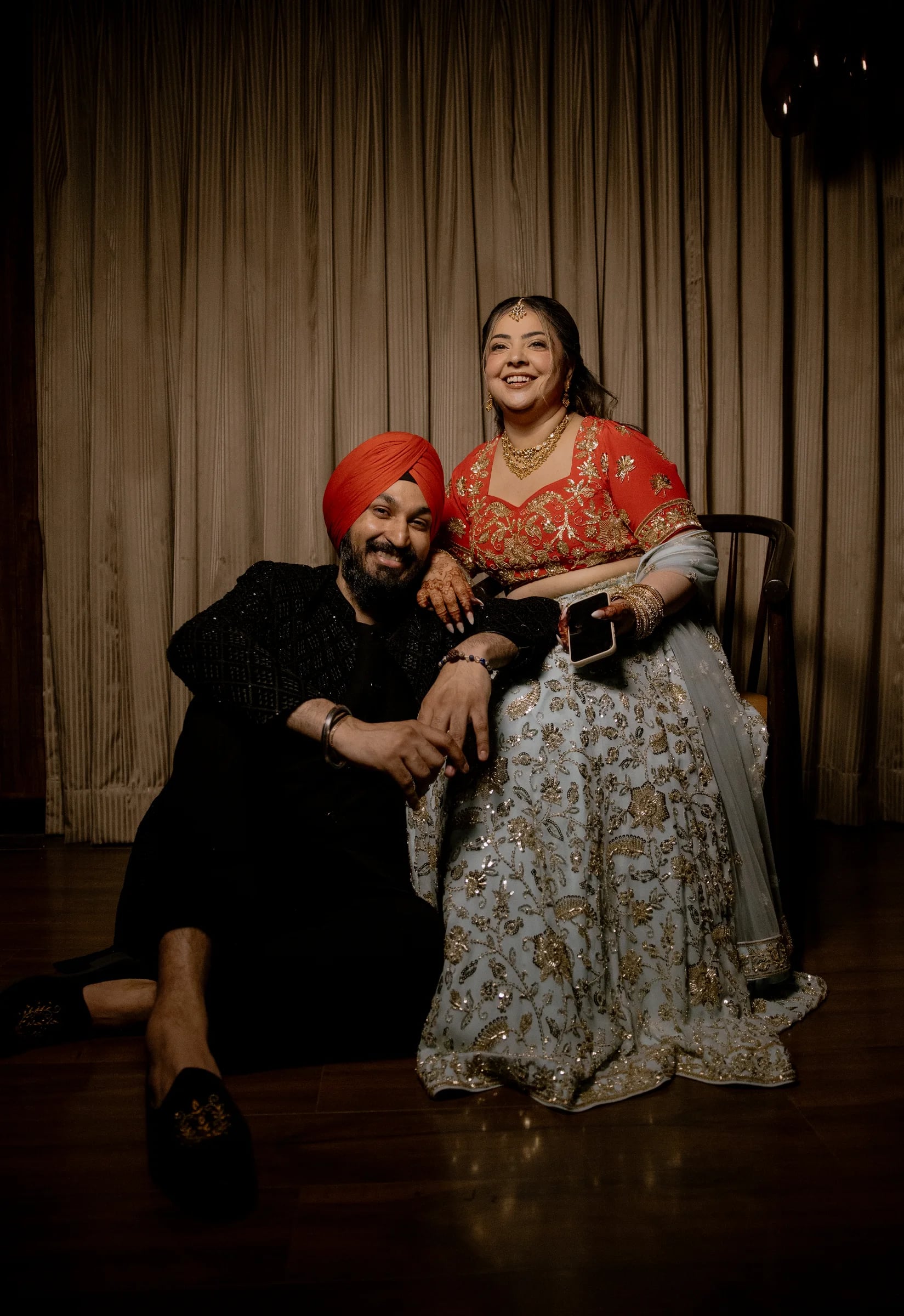 Cinematic portrait of an Indian couple at a lakeside palace terrace