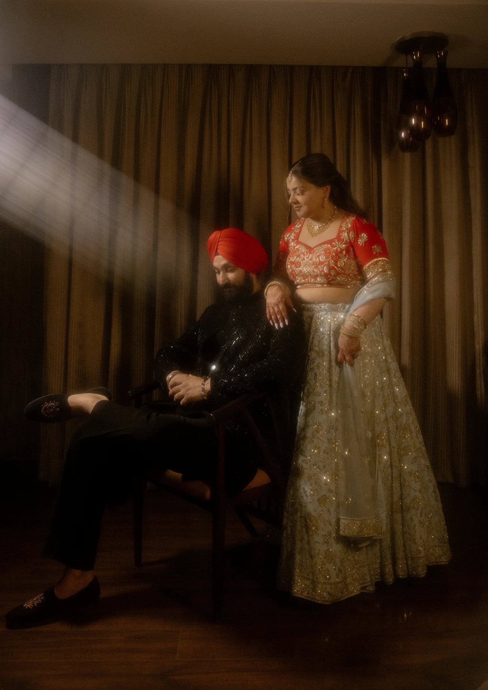 Cinematic portrait of an Indian couple at a lakeside palace terrace